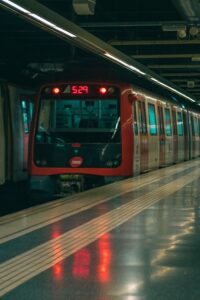 Red subway train at a metro station platform ready for departure.